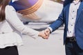 Two business man and woman making handshake in the city. Business etiquette, congratulation, merger and acquisition concepts