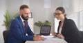 Two business partners discussing startup project sitting at office desk Royalty Free Stock Photo