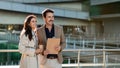 Two business partners, mature man and woman working outdoors