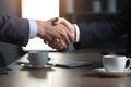 Two business partners shaking hands over briefing table after successful collaboration in a modern office, acceptance image Royalty Free Stock Photo
