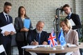 Two business partners signing a document. The European Union The United Kingdom Royalty Free Stock Photo