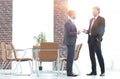 Two business executives talking about business in the office. Royalty Free Stock Photo