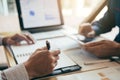 Two business partnership coworkers discussing a financial planning graph and company during a budget meeting in office room Royalty Free Stock Photo