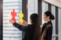 Two business people assembling jigsaw puzzle, team support and help concept Royalty Free Stock Photo