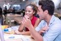 Business people colleagues talking about planning project in the workplace. Man holding pencil in his hand with woman sitting Royalty Free Stock Photo