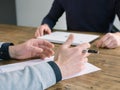 Two business people have meeting round a wooden table at an office