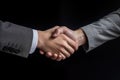 Two business people shaking hands black background Royalty Free Stock Photo