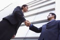 Two business people shaking hands outside office Royalty Free Stock Photo