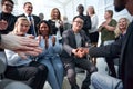 Two business people shaking hands while sitting in meeting room Royalty Free Stock Photo