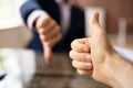 Two Business People Showing Thumbs Up And Thumbs Down Sign Royalty Free Stock Photo