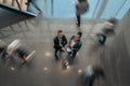Two business people standing in busy office with a blur of people walking past Royalty Free Stock Photo