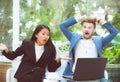 Two business surprised looking at laptop computer with shocked Royalty Free Stock Photo