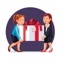 Two business woman carrying big holiday gift box Royalty Free Stock Photo