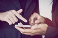 Two business woman looking at mobile phone talking about their project Royalty Free Stock Photo