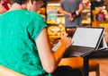 Two business women working in cafe with laptop and using mobile phone. Royalty Free Stock Photo