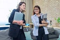 Two business women colleagues talking together in office Royalty Free Stock Photo