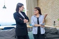 Two business women colleagues talking together in office Royalty Free Stock Photo