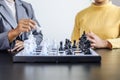 Two business women competitors playing chess board game, business competition concept, business plan to be the number one company Royalty Free Stock Photo