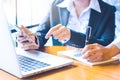 Two business women hand working in a loptop computer and writing Royalty Free Stock Photo