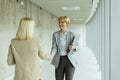 Business women handshaking in the office corridor Royalty Free Stock Photo