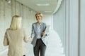 Business women handshaking in the office corridor Royalty Free Stock Photo