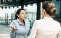 Two business women having a casual meeting or discussion in the city. Royalty Free Stock Photo