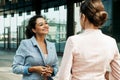 Two business women having a casual meeting or discussion near a modern office Royalty Free Stock Photo