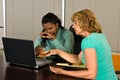 Two business women look at a laptop computer Royalty Free Stock Photo