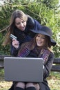 Two business women in the park to buy a laptop Royalty Free Stock Photo