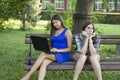 Two business women in the park to buy a laptop Royalty Free Stock Photo