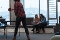 Two business women sitingt in a modern coworking space on a break from work and relax using a laptop. Selective focus Royalty Free Stock Photo