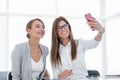 Two business women taking selfies in the office Royalty Free Stock Photo