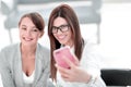 Two business women taking selfies in the office Royalty Free Stock Photo