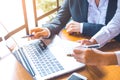 Two business women working in a notebook computer and writing on Royalty Free Stock Photo