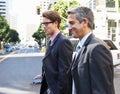 Two Businessman Chatting Whilst Crossing Street Royalty Free Stock Photo