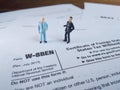 Two businessman discussion about usa tax form, w-8ben, certificate of foreign status of beneficial owner for united states tax wit Royalty Free Stock Photo