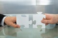 Two businessman hands holding jigsaw puzzle Royalty Free Stock Photo