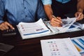 Two businessman planning strategy on desk with paperwork, Strategist team analyze data or information Royalty Free Stock Photo