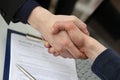 Two businessman shake hands as hello in office closeup Royalty Free Stock Photo