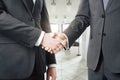 Two businessman shaking hands in a light modern office Royalty Free Stock Photo