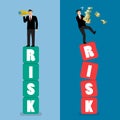 Two businessman standing on risk blocks