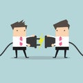 Two businessman trying to connect electric plug Royalty Free Stock Photo