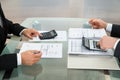 Two businessman using calculator in office Royalty Free Stock Photo