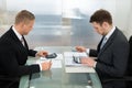 Two businessman using calculator at workplace Royalty Free Stock Photo