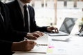 Two businessmen are analyzing earnings on a graph to plan investments Royalty Free Stock Photo