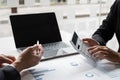 Two businessmen are analyzing earnings on a graph to plan investments Royalty Free Stock Photo