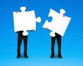 Two businessmen assembling puzzles Royalty Free Stock Photo