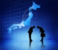 Two Businessmen Bowing Heads To Each Other And A Japan Cartograph Above Them Royalty Free Stock Photo