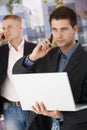 Two businessmen busy making phone call Royalty Free Stock Photo