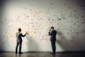 Businessmen draw graphs on the board. Two businessmen in classic suits. Concept: revenue growth, business planning and forecasts Royalty Free Stock Photo